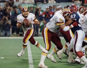 FILE - In this Jan. 26, 1992, file photo, Washington Redskins' Don Warren (85) keeps Buffalo Bills Cornelius Bennet (97) away from Redskins quarterback Mark Rypien during NFL football's Super Bowl XXVI in Minneapolis. Rypien passed for 292 yards and two touchdowns to lead the Redskins to their third Super Bowl title. (AP Photo/Jim Mone, File)